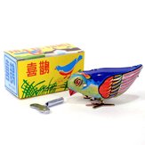 Brinquedo mecânico de lata antigo com pássaro bicando